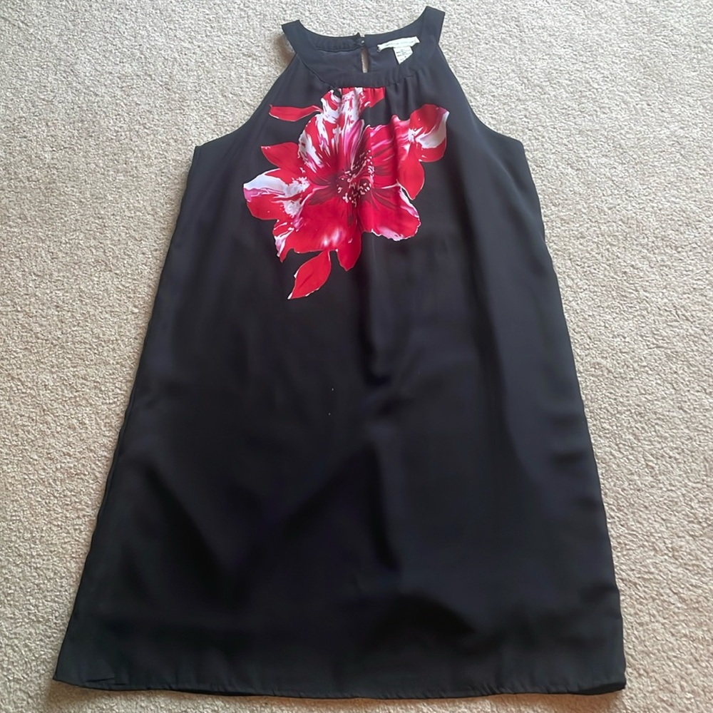 Black sheath dress with high neck.